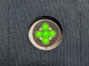 Close-up of the cut-out in the vest pocket with the watch's green heart-rate sensor showing through